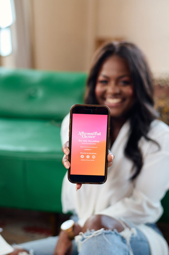 woman holding a iPhone with her business branding on screen