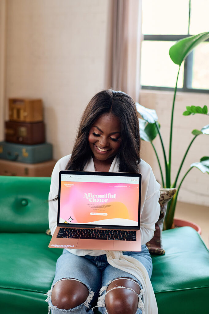 woman holding a laptop with her business branding on screen