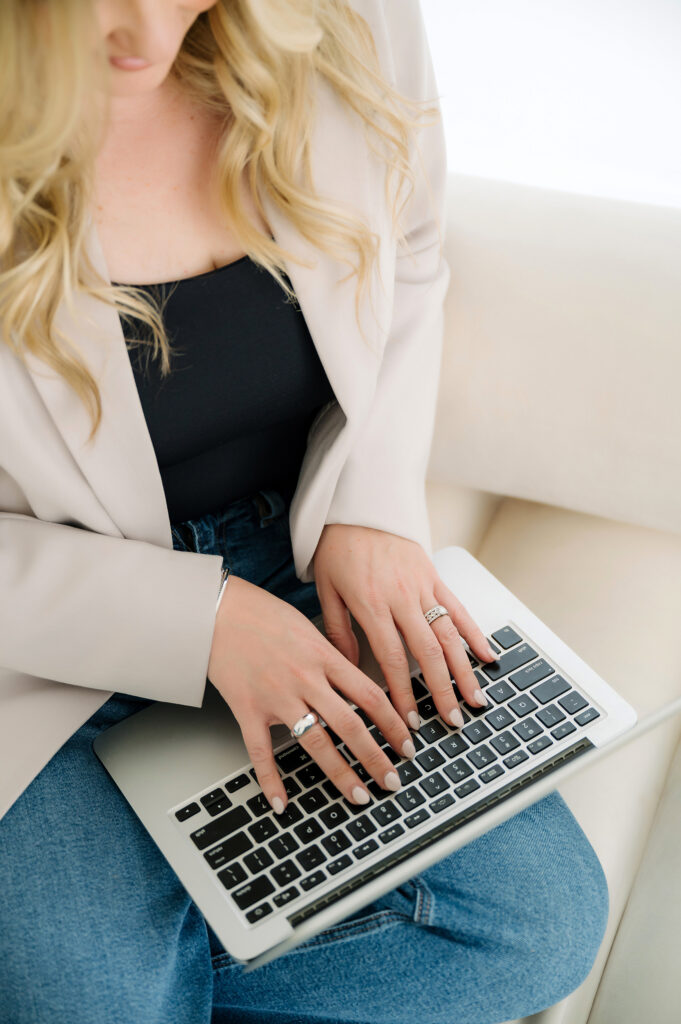 Woman's hands typing on laptop keyboard