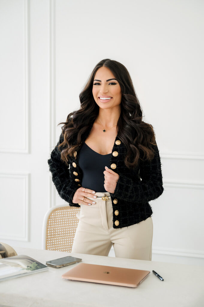 Smiling professional woman in black and white outfit, exemplifying branding photography